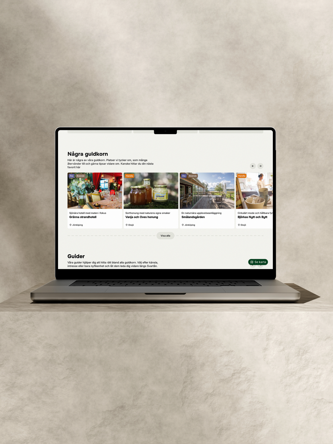 Desktop on stone backround displaying a page with cards of locations on the screen